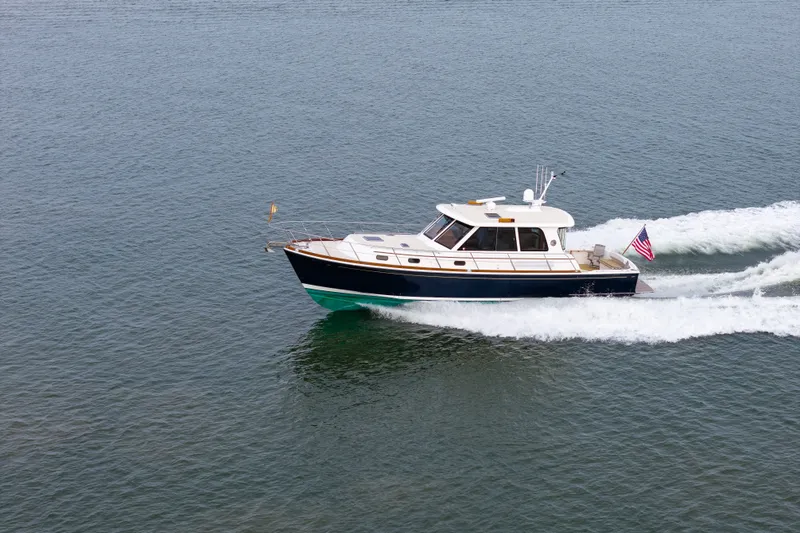 Slide: The Image of 2009 Grand Banks 45 Eastbay SX cruising on open water, displaying American flag. - 92