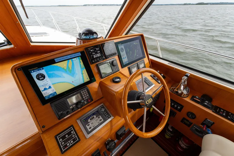 Slide: The Image of Helm of 2009 Grand Banks 45 Eastbay SX with navigation screens and wooden steering wheel. - 30