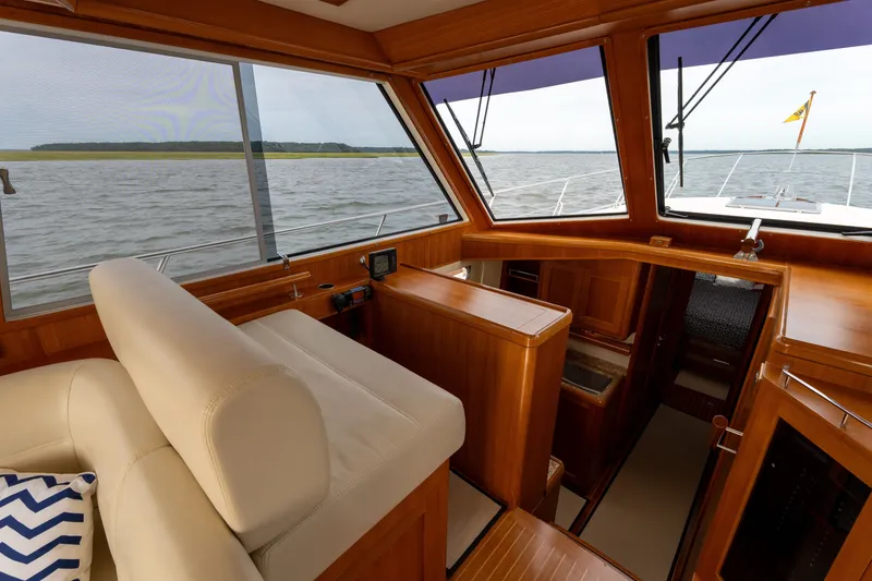 Slide: The Image of Interior view of 2009 Grand Banks 45 Eastbay SX yacht with wooden finish and water view. - 25