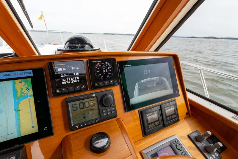 Slide: The Image of 2009 Grand Banks 45 Eastbay SX helm with navigation and control systems on display. - 34