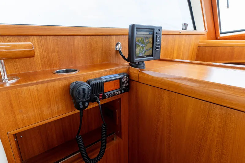 Slide: The Image of 2009 Grand Banks 45 Eastbay SX interior with navigation equipment and radio. - 26
