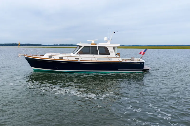 Slide: The Image of 2009 Grand Banks 45 Eastbay SX yacht on calm water, side view. - 87