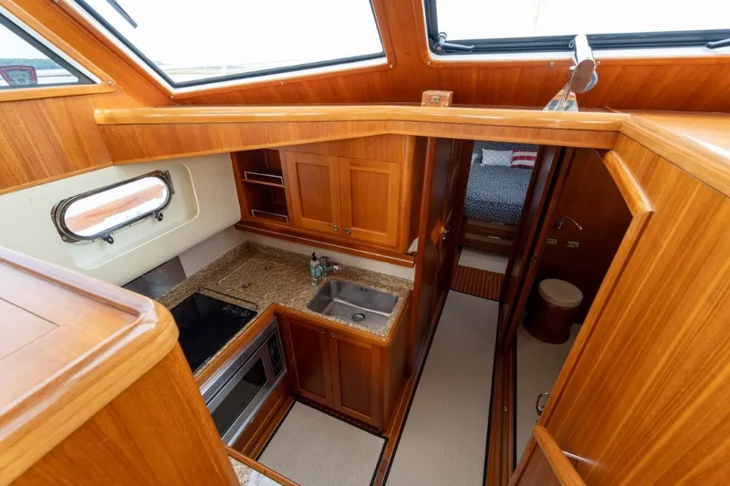 Slide: The Image of Luxurious 2009 Grand Banks 45 Eastbay SX yacht interior with wood finish and modern amenities. - 49