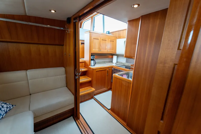 Slide: The Image of Luxurious 2009 Grand Banks 45 Eastbay SX yacht interior with wooden cabinetry and cozy seating. - 64