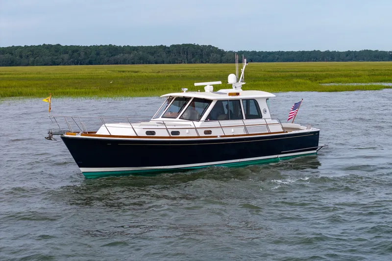 Slide: The Image of 2009 Grand Banks 45 Eastbay SX yacht cruising on a scenic waterway. - 94