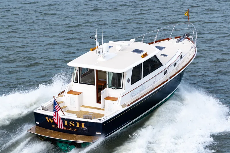 Slide: The Image of 2009 Grand Banks 45 Eastbay SX cruising on open water, rear view. - 15