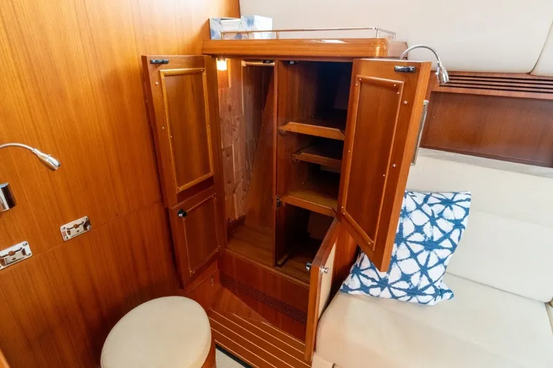 Slide: The Image of Wooden interior cabinet on 2009 Grand Banks 45 Eastbay SX yacht with open doors and seating. - 62