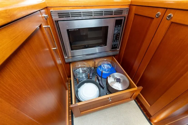 Slide: The Image of Galley kitchen in 2009 Grand Banks 45 Eastbay SX with microwave and cookware drawer. - 59