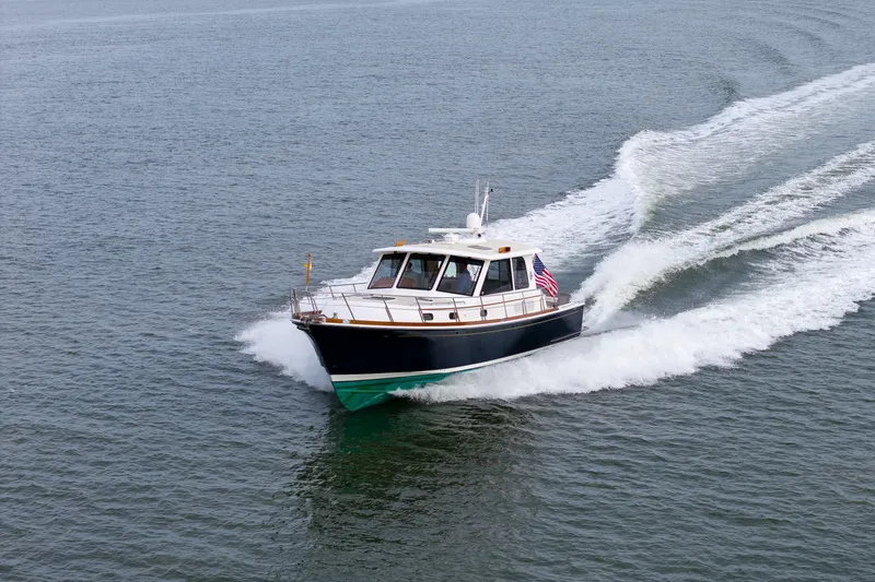 Slide: The Image of 2009 Grand Banks 45 Eastbay SX cruising on open water, creating a wake. - 100