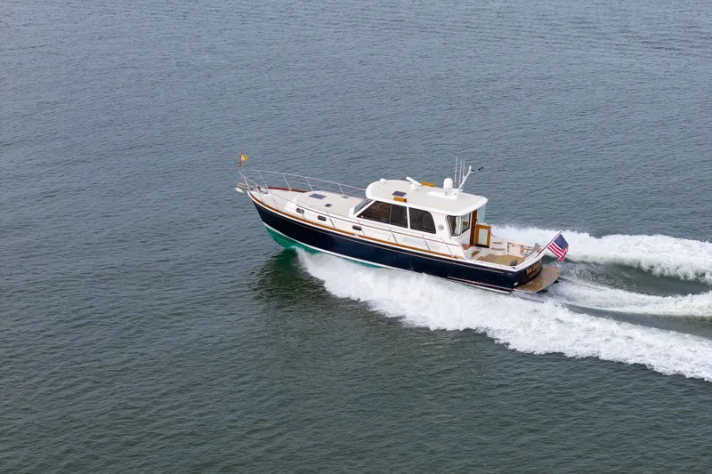 Slide: The Image of 2009 Grand Banks 45 Eastbay SX yacht cruising on open water. - 91