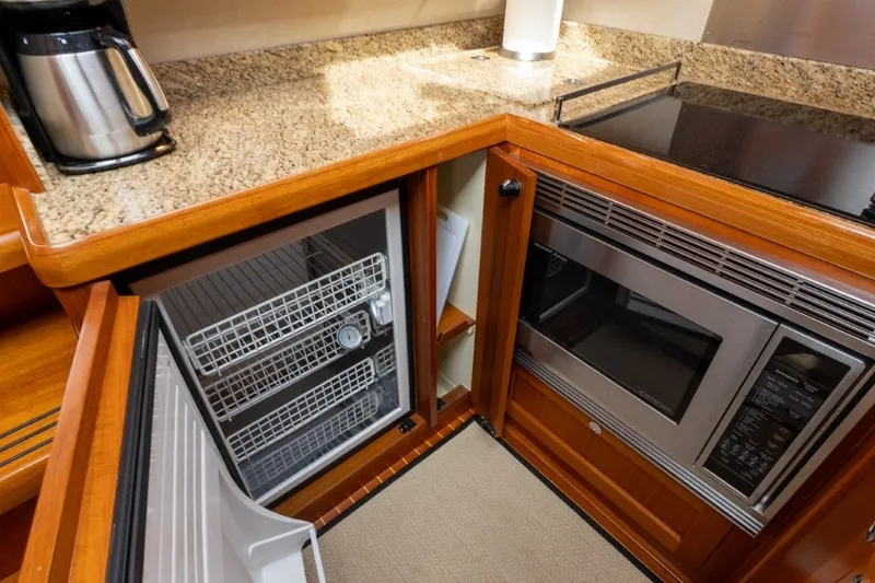 Slide: The Image of Luxury yacht kitchen with granite countertop, microwave, and mini-fridge on 2009 Grand Banks 45 Eastbay SX. - 54
