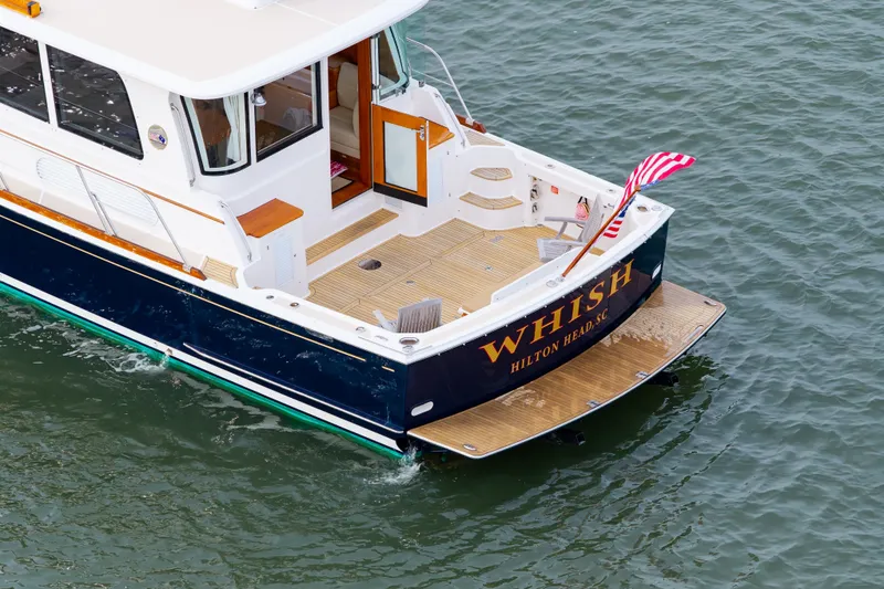 Slide: The Image of 2009 Grand Banks 45 Eastbay SX yacht named "Whish" on water, rear view. - 99