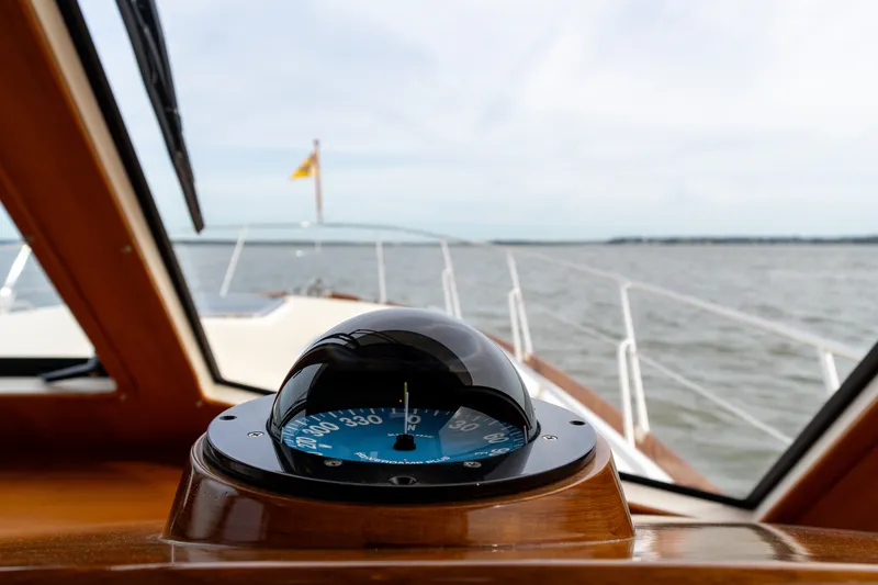 Slide: The Image of Compass view from 2009 Grand Banks 45 Eastbay SX yacht navigating open waters. - 35