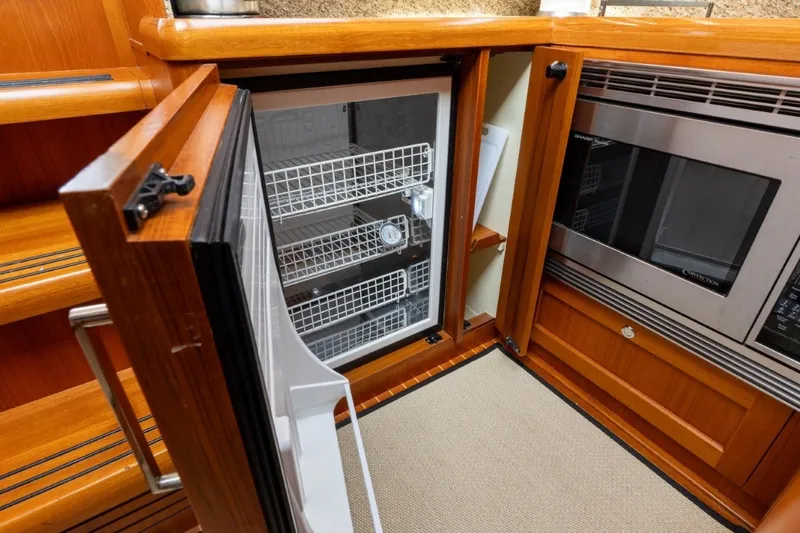 Slide: The Image of Luxury yacht kitchen with open fridge and microwave, Grand Banks 45 Eastbay SX, 2009 model. - 52