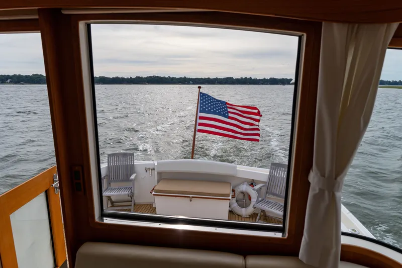 Slide: The Image of View from 2009 Grand Banks 45 Eastbay SX yacht, American flag waving on open water. - 21