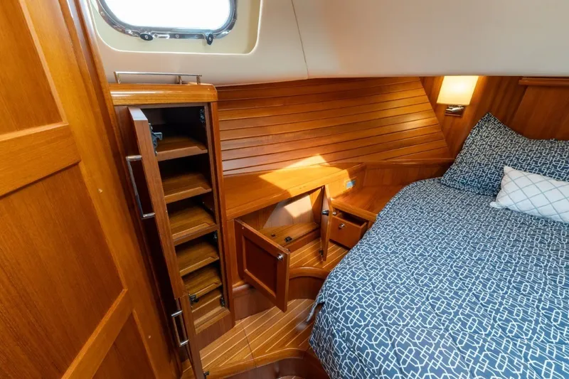 Slide: The Image of Luxurious 2009 Grand Banks 45 Eastbay SX cabin with wooden cabinetry and cozy bedding. - 75