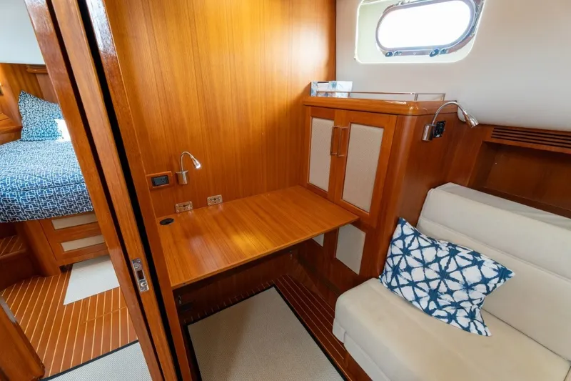 Slide: The Image of Luxurious 2009 Grand Banks 45 Eastbay SX cabin interior with wooden finish and cozy seating. - 66