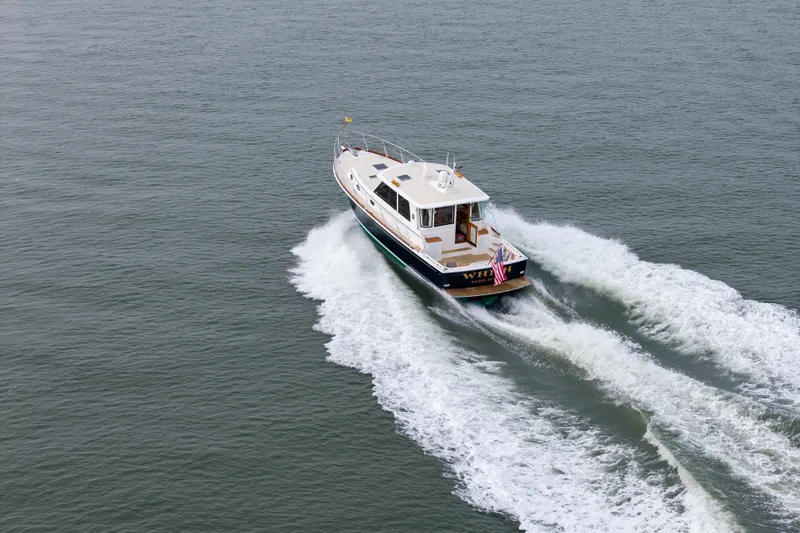 Slide: The Image of 2009 Grand Banks 45 Eastbay SX cruising on open water, creating a wake. - 101