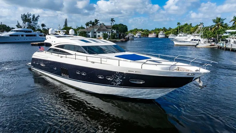 Slide: The Image of Luxurious 2010 Princess V78 yacht cruising on a sunny day in a scenic marina. - 1