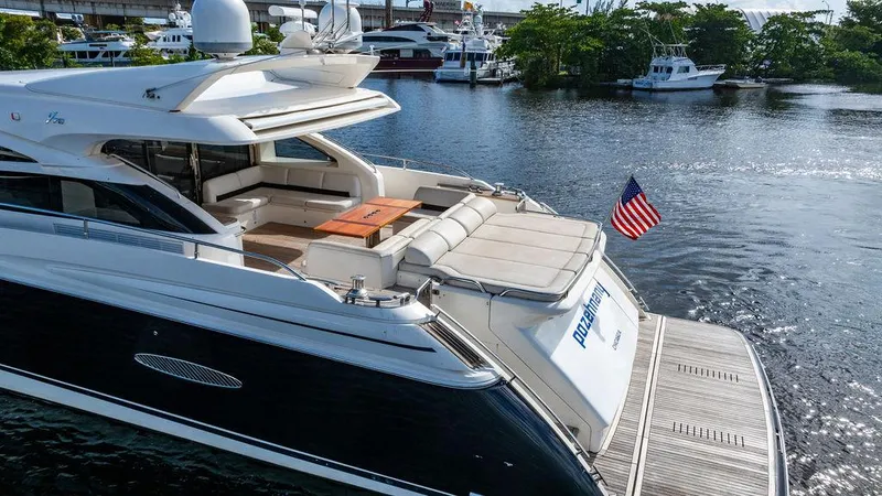 Slide: The Image of Luxury 2010 Princess V78 yacht docked, featuring spacious deck and American flag. - 6