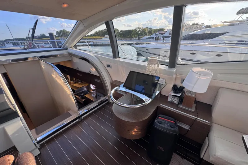 Slide: The Image of Luxurious interior of 2006 Azimut 68S yacht with modern decor and marina view. - 18