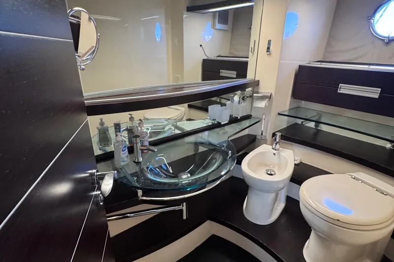 Slide: The Image of Luxurious bathroom in 2006 Azimut 68S yacht with modern fixtures and glass sink. - 80