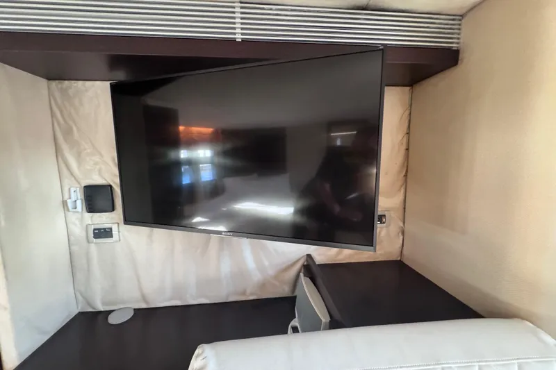 Slide: The Image of Flat-screen TV in 2006 Azimut 68S yacht interior, mounted on beige wall. - 83