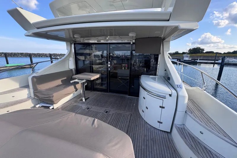 Slide: The Image of Luxurious 2006 Azimut 68S yacht deck with seating and marina view. - 15
