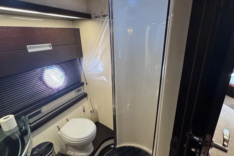 Slide: The Image of Luxurious bathroom in 2006 Azimut 68S yacht with modern fixtures and porthole window. - 55