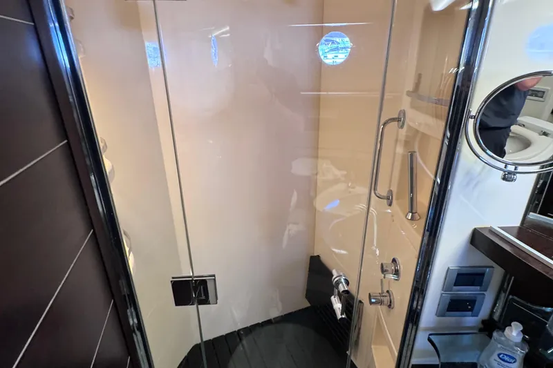 Slide: The Image of Luxurious bathroom shower in a 2006 Azimut 68S yacht, featuring glass door and modern fixtures. - 82