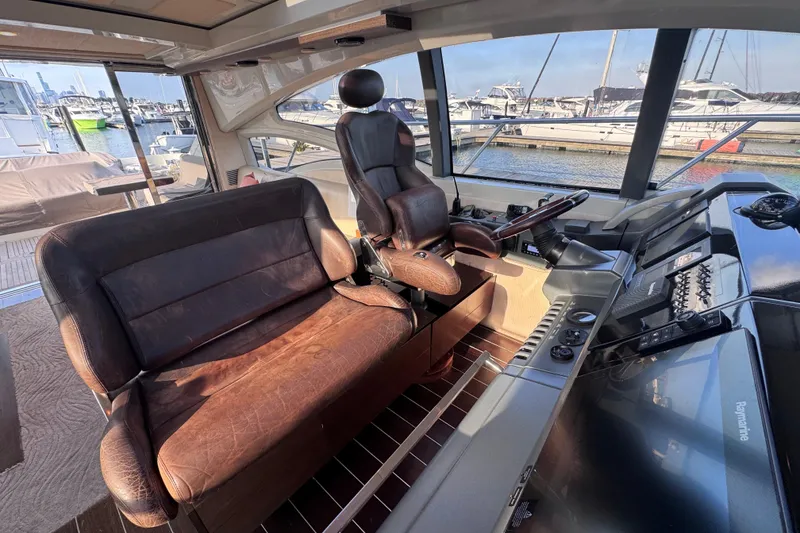 Slide: The Image of Interior of 2006 Azimut 68S yacht with leather seating and modern controls. - 36