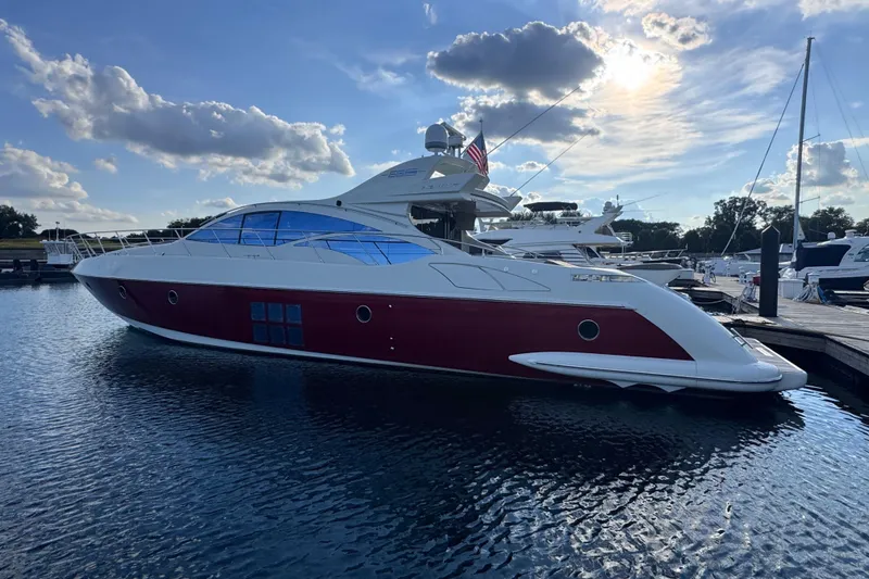 The Image of Luxury 2006 Azimut 68S yacht docked at marina under a partly cloudy sky. - 0