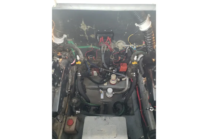 Slide: The Image of Engine compartment of a 1988 Sea Ray 390 Express Cruiser with visible wiring and components. - 30