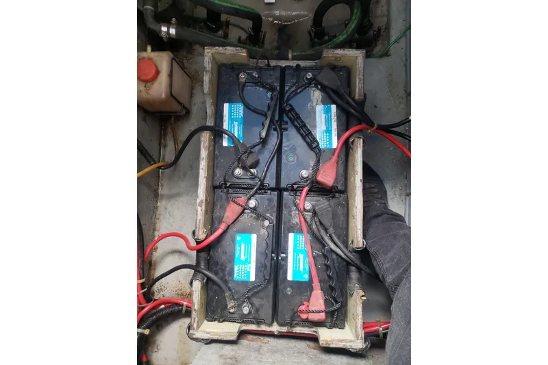 Slide: The Image of 1988 Sea Ray 390 Express Cruiser battery compartment with connected cables. - 31