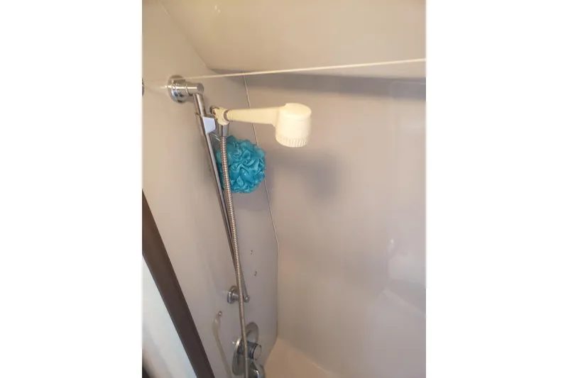 Slide: The Image of Shower area in 1988 Sea Ray 390 Express Cruiser with blue bath sponge. - 10