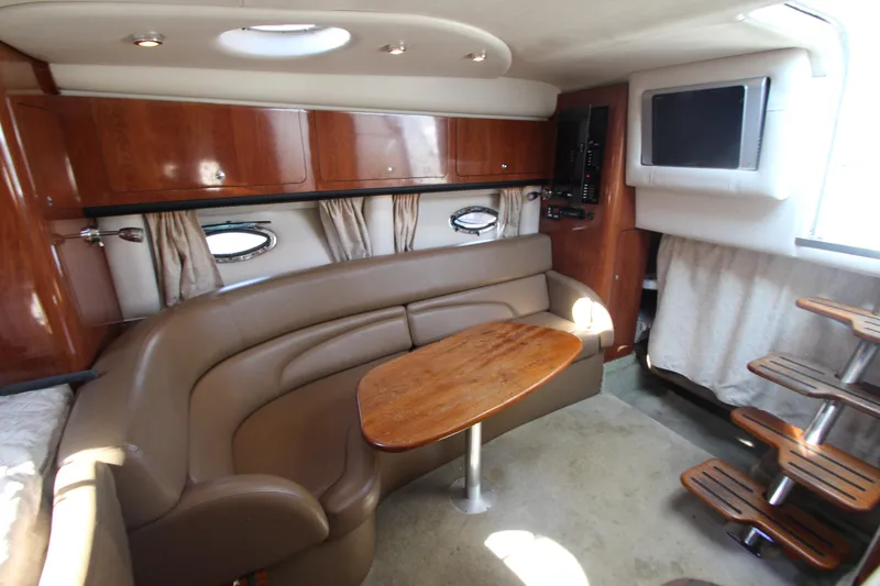Slide: The Image of Interior of 2008 Crownline 340 CR yacht with leather seating and wooden table. - 29