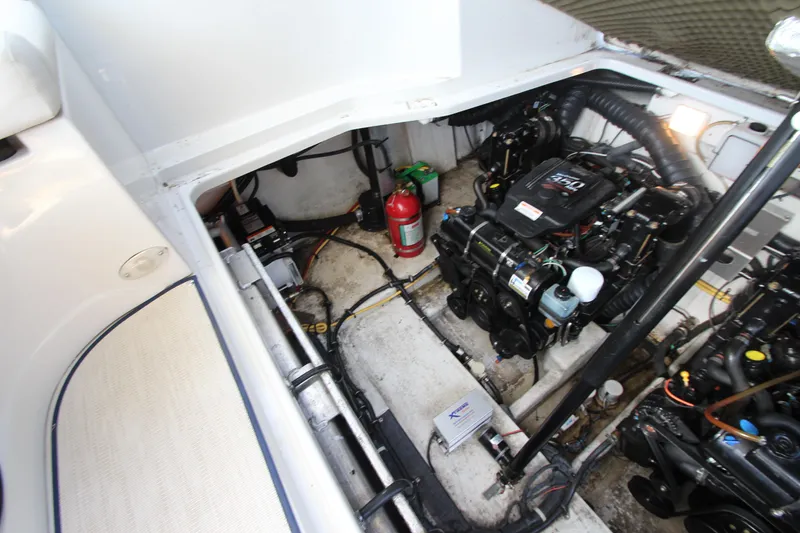 Slide: The Image of Engine compartment of a 2008 Crownline 340 CR boat, featuring dual engines and safety equipment. - 45