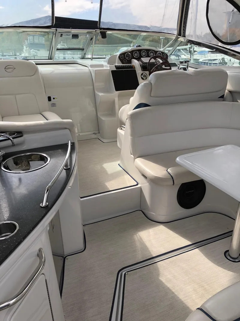 Slide: The Image of 2008 Crownline 340 CR boat interior with white seating and modern dashboard. - 10