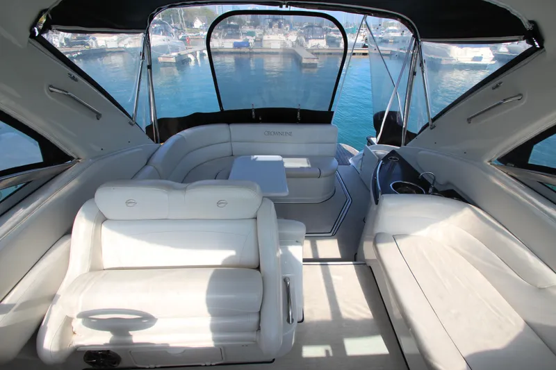 Slide: The Image of 2008 Crownline 340 CR yacht interior with white seating and marina view. - 8