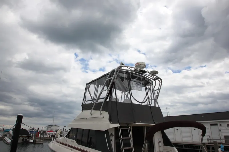 Slide: The Image of 1990 Silverton 34 Convertible boat docked under cloudy sky. - 48