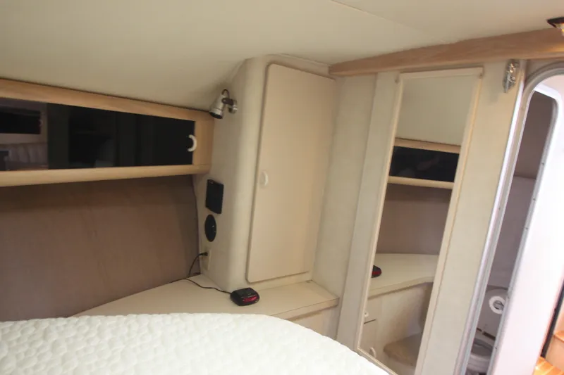 Slide: The Image of 1990 Silverton 34 Convertible cabin interior with storage and bed. - 22