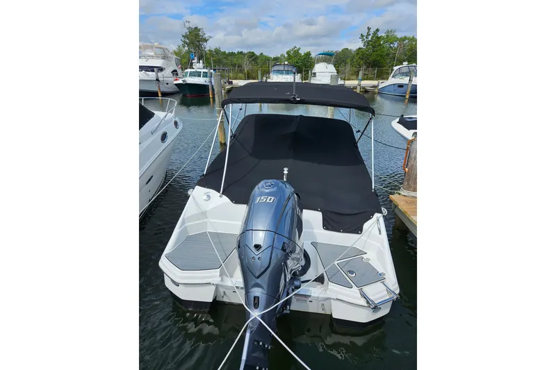 The Image of 2024 NauticStar 223DC Sport Deck boat docked with Yamaha 150 engine. - 0