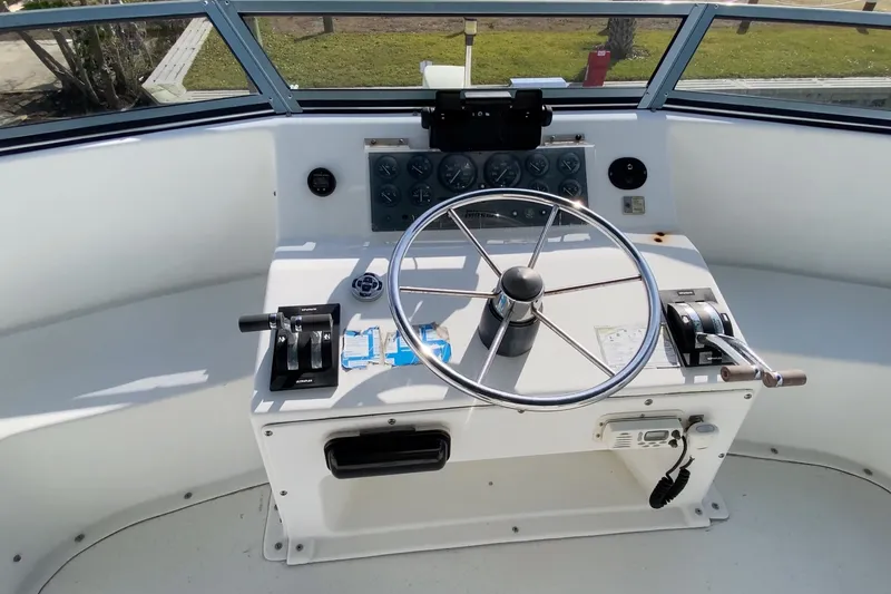 Slide: The Image of Helm of a 2000 Gibson 37 Sport Series boat with steering wheel and controls. - 13