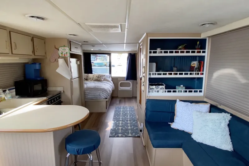 Slide: The Image of Interior of a 2000 Gibson 37 Sport Series houseboat with cozy living area and kitchen. - 17