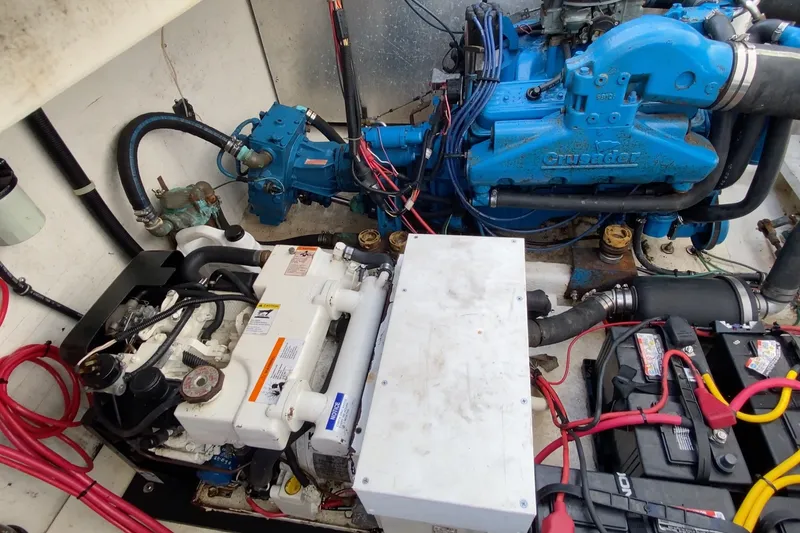 Slide: The Image of Engine room of a 2000 Gibson 37 Sport Series boat with visible machinery and wiring. - 26