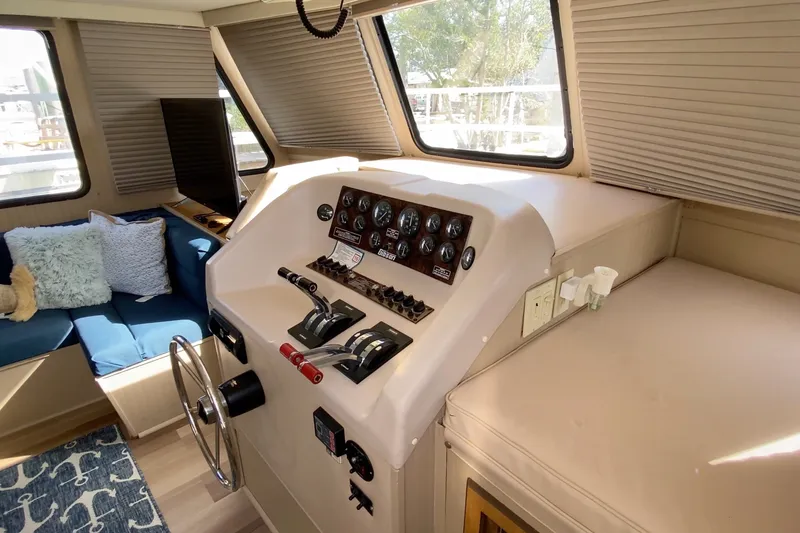Slide: The Image of Interior helm of 2000 Gibson 37 Sport Series boat with control panel and seating area. - 15