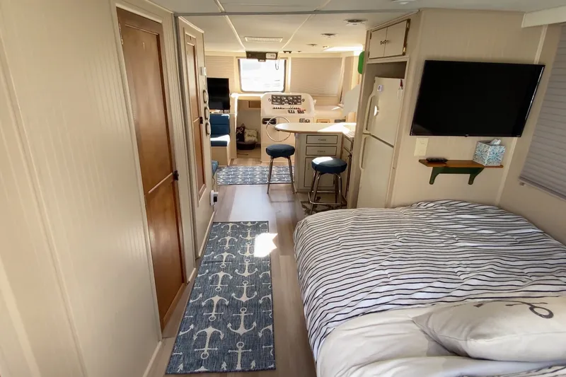 Slide: The Image of Interior of a 2000 Gibson 37 Sport Series boat with cozy bedroom and modern amenities. - 20