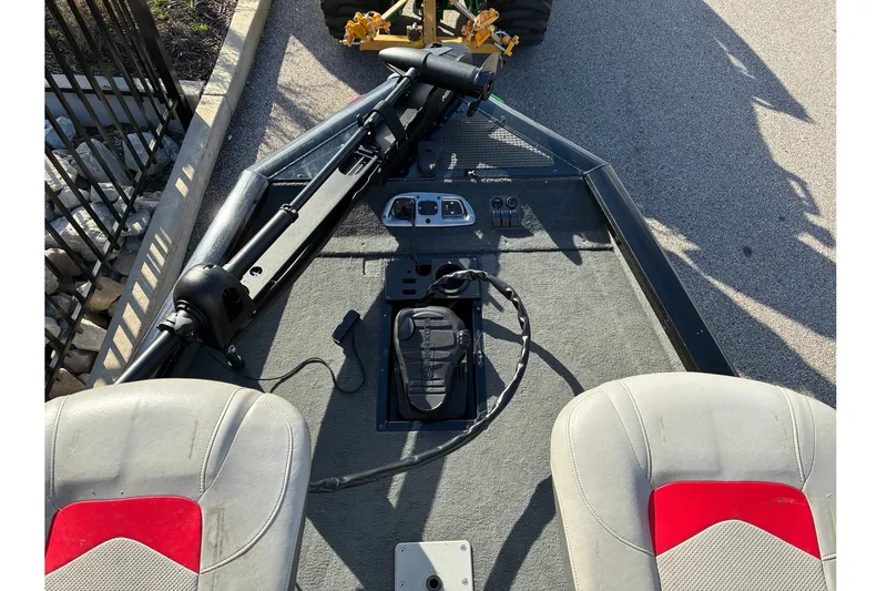 Slide: The Image of 2014 Tracker Pro Team 190 TX boat interior with seats and control panel. - 14