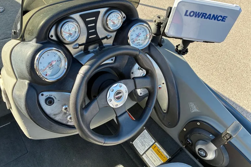 Slide: The Image of 2014 Tracker Pro Team 190 TX boat dashboard with steering wheel and Lowrance display. - 18