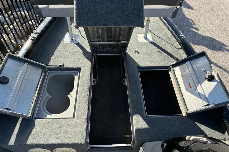 Slide: The Image of 2014 Tracker Pro Team 190 TX boat with open storage compartments. - 15